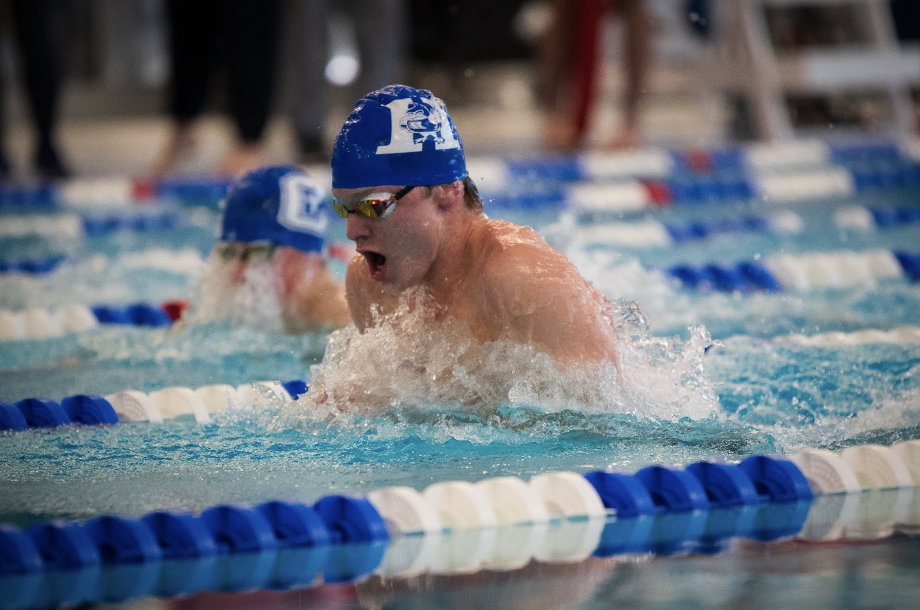 Griffin Barlow (12) swims the 100-yard breaststroke during the postseason.